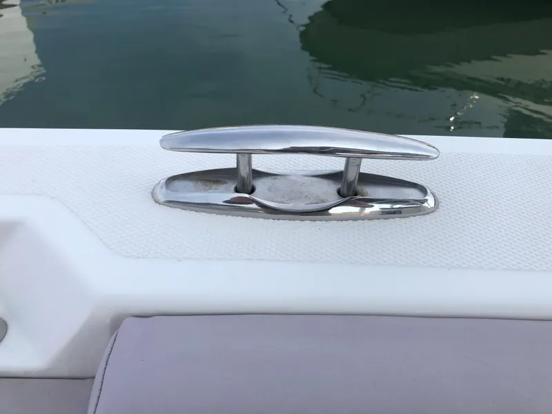 Slide: The Image of Stainless steel cleat on 2019 Wellcraft 242 Fisherman boat, docked on calm water. - 28