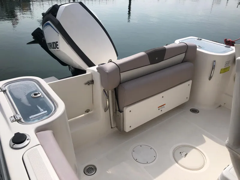 Slide: The Image of 2019 Wellcraft 242 Fisherman boat interior with seating and outboard motor. - 32