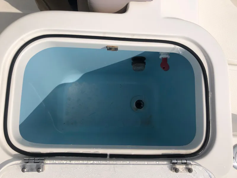 Slide: The Image of Livewell compartment on a 2019 Wellcraft 242 Fisherman boat, open and empty. - 35