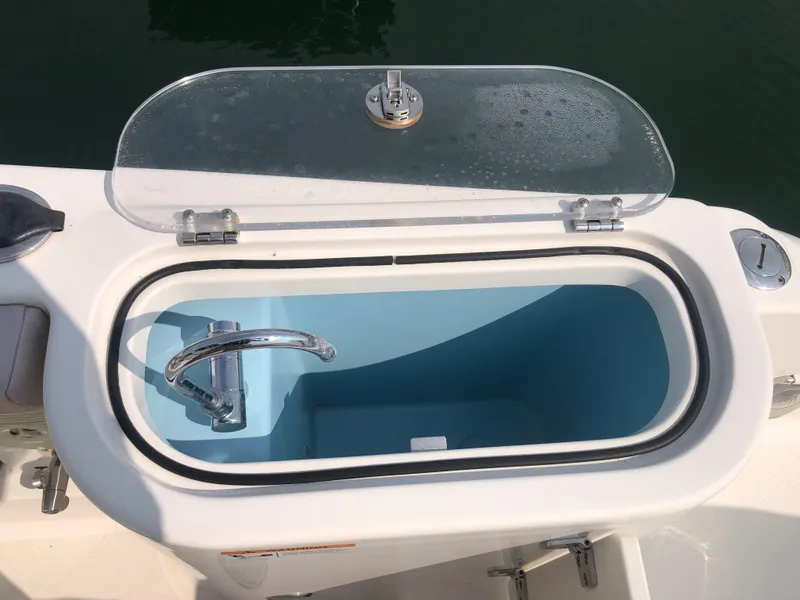 Slide: The Image of Livewell on 2019 Wellcraft 242 Fisherman boat, open lid, blue interior. - 37