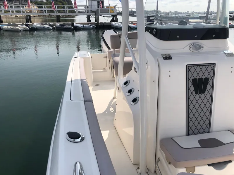 Slide: The Image of 2019 Wellcraft 242 Fisherman boat docked, showcasing sleek design and spacious deck. - 38