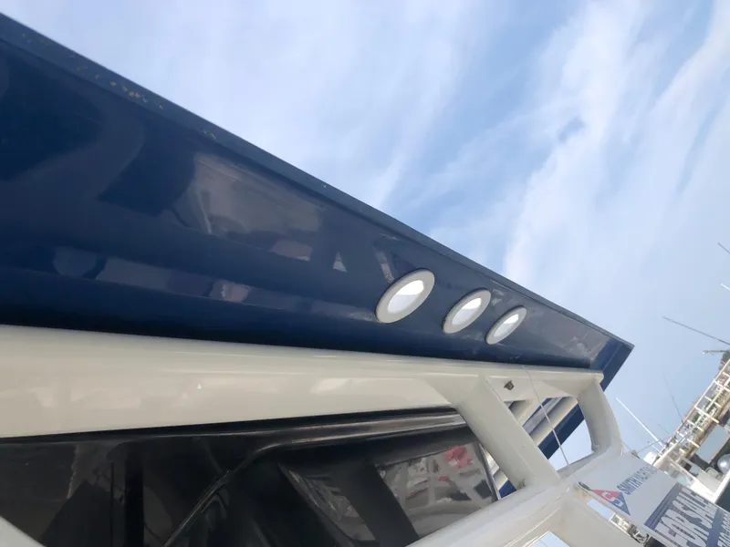 Slide: The Image of 2019 Wellcraft 242 Fisherman boat with blue and white exterior under a clear sky. - 39