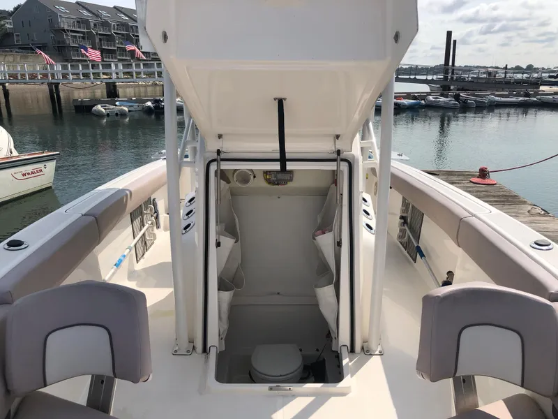 Slide: The Image of 2019 Wellcraft 242 Fisherman boat with open console, docked at marina. - 42