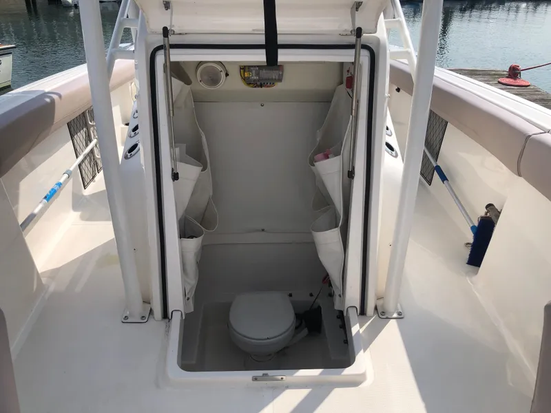 Slide: The Image of 2019 Wellcraft 242 Fisherman boat interior with open hatch and marine toilet. - 43