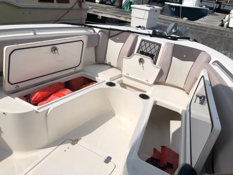Slide: The Image of 2019 Wellcraft 242 Fisherman boat interior with open storage compartments and life jackets. - 47