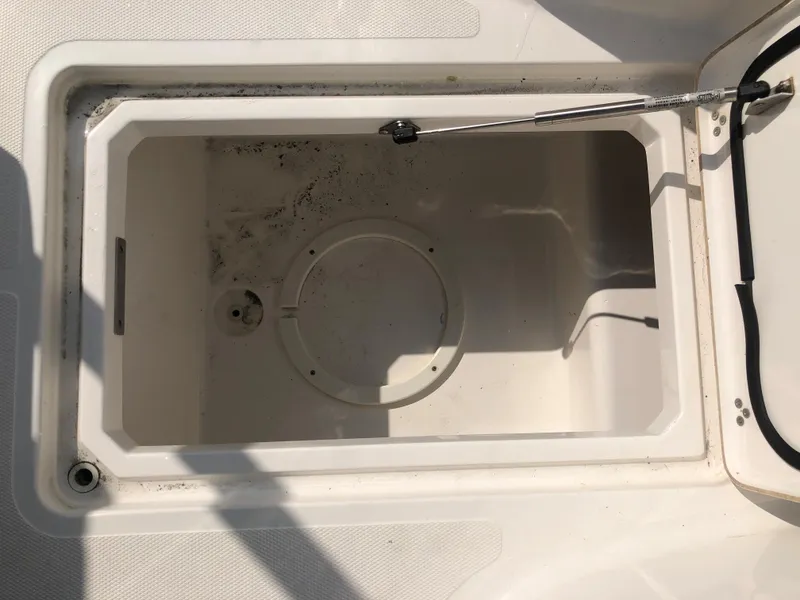 Slide: The Image of Open storage compartment on a 2019 Wellcraft 242 Fisherman boat. - 49