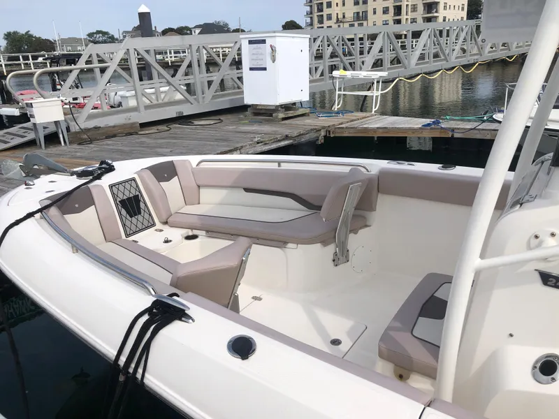 Slide: The Image of 2019 Wellcraft 242 Fisherman boat docked, featuring spacious seating and modern design. - 5