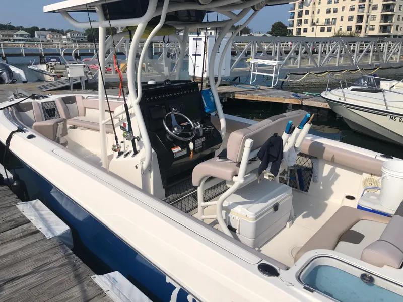 Slide: The Image of 2019 Wellcraft 242 Fisherman boat docked at a marina. - 6
