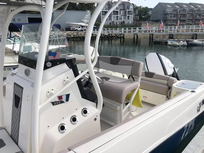 Slide: The Image of 2019 Wellcraft 242 Fisherman boat docked, featuring a sleek console and comfortable seating. - 7