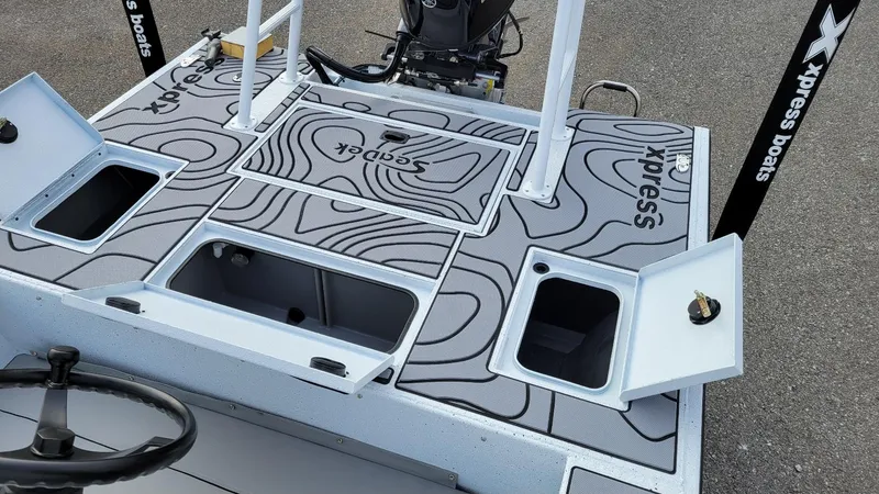 Slide: The Image of 2025 Xpress Skiff 185 boat deck with Yamaha Vmax 115 SHO engine, storage compartments open. - 12