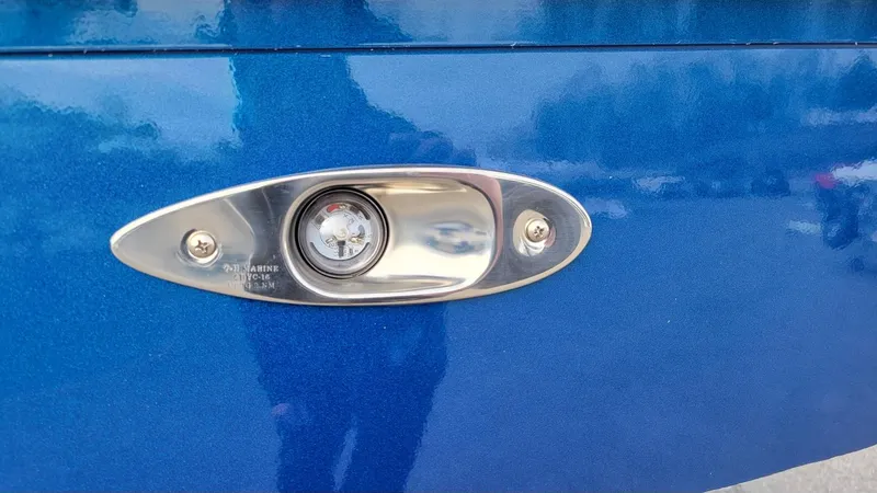Slide: The Image of Close-up of 2025 Xpress Skiff 185 boat's blue hull with a chrome light fixture. - 16