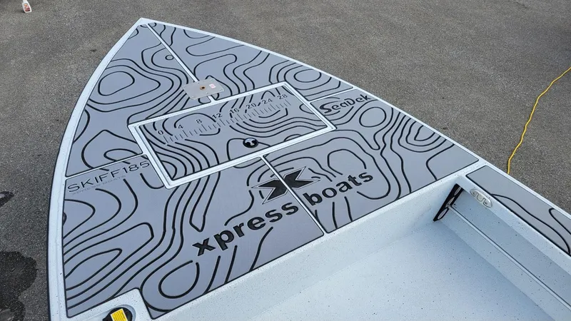 Slide: The Image of 2025 Xpress Skiff 185 boat deck with Yamaha Vmax 115 SHO, featuring stylish topographic design. - 19