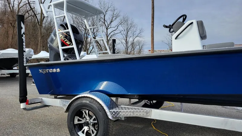 Slide: The Image of 2025 Xpress Skiff 185 with Yamaha Vmax 115 SHO, blue boat on trailer. - 4