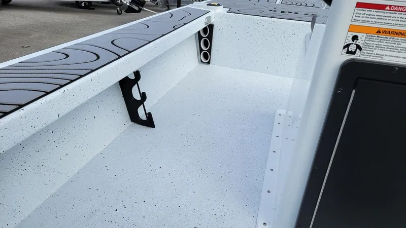 Slide: The Image of 2025 Xpress Skiff 185 interior with rod holders and non-slip flooring. - 9