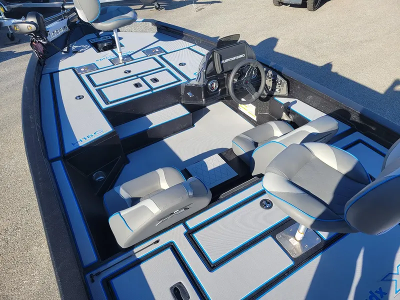 Slide: The Image of 2024 Xpress H18C Crappie Edition boat interior with seating and steering console. - 10