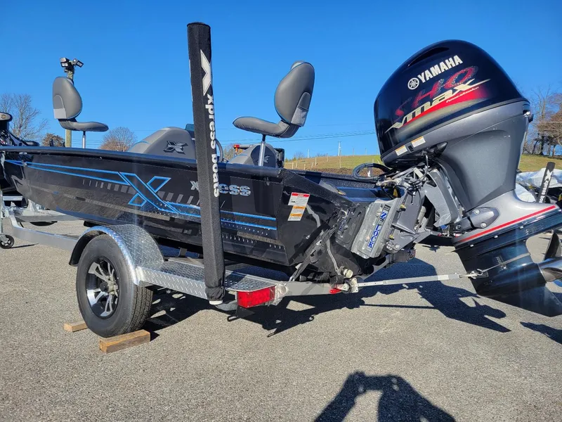Slide: The Image of 2024 Xpress H18C Crappie Edition boat with Yamaha VMAX engine, parked on trailer. - 2