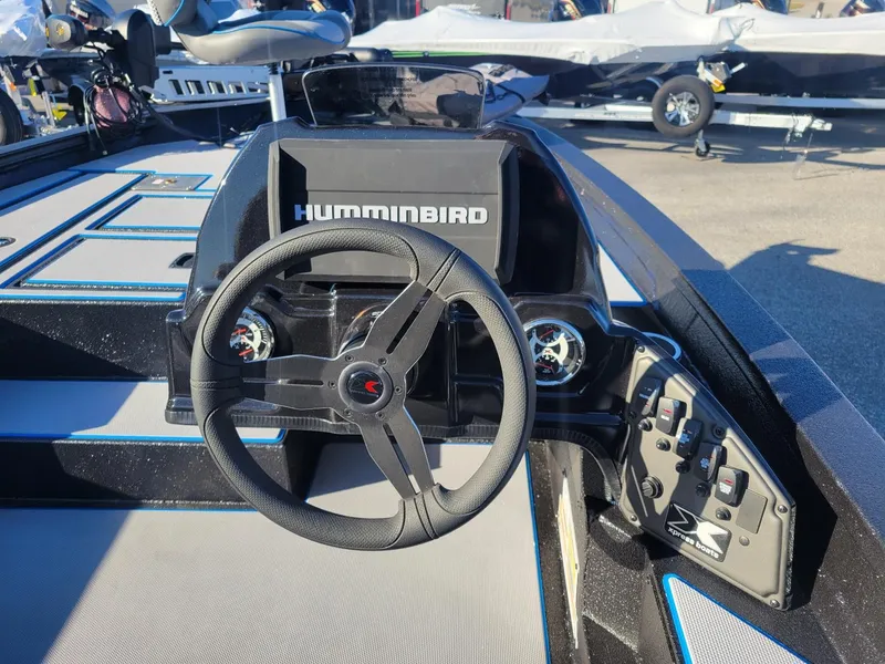 Slide: The Image of 2024 Xpress H18C Crappie Edition boat dashboard with steering wheel and Humminbird display. - 4