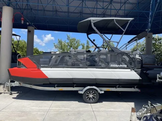Slide: The Image of 2023 Sea-Doo Switch® Sport 21-230 hp Galvanized pontoon boat on trailer. - 1