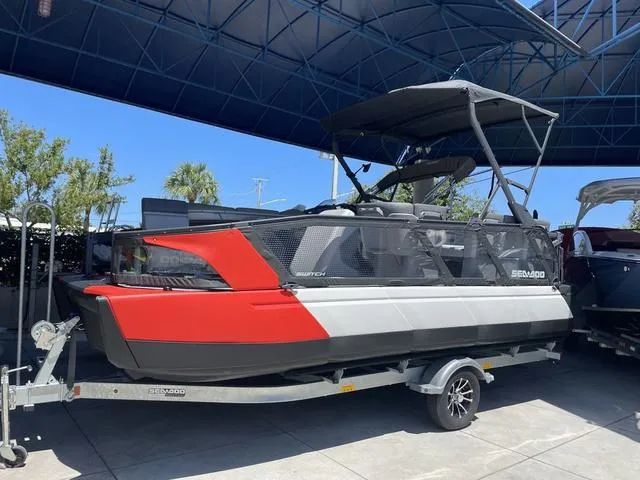 Slide: The Image of 2023 Sea-Doo Switch® Sport 21-230 hp Galvanized boat on trailer under canopy. - 3