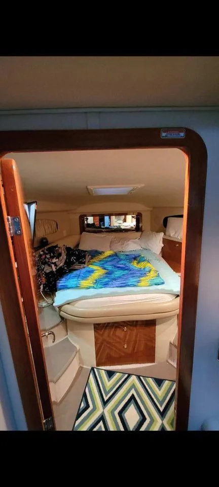 Slide: The Image of 1998 Sea Ray 420 Aft Cabin interior with colorful bedding and cozy design. - 5