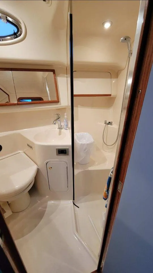 Slide: The Image of 1998 Sea Ray 420 Aft Cabin bathroom with shower, sink, and toilet. - 8