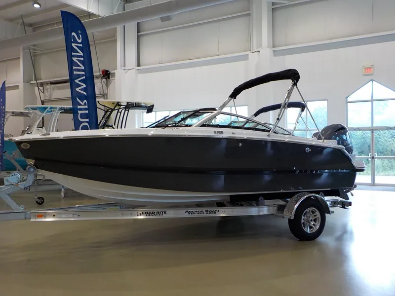 Slide: The Image of 2024 Four Winns H1 OB boat on display in a showroom. - 1