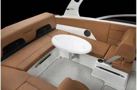 Slide: The Image of 2024 Four Winns H1 OB boat interior with brown seating and white table. - 2