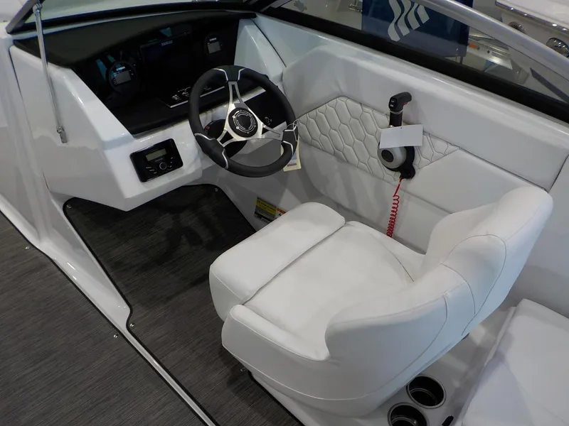 Slide: The Image of 2024 Four Winns H1 OB boat cockpit with steering wheel and white captain's chair. - 21