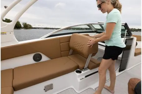 Slide: The Image of Woman adjusting seat on 2024 Four Winns H1 OB boat. - 3