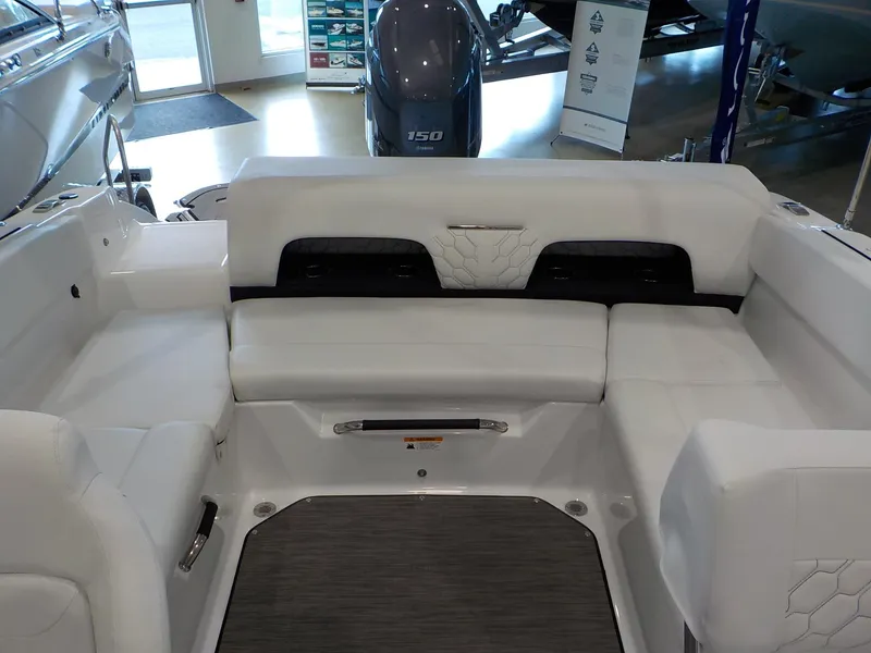 Slide: The Image of 2024 Four Winns H1 OB boat interior with white seating and modern design. - 33
