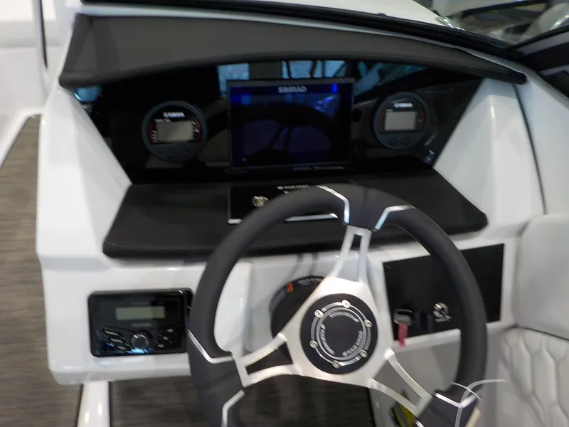 Slide: The Image of 2024 Four Winns H1 OB boat dashboard with steering wheel and digital gauges. - 35