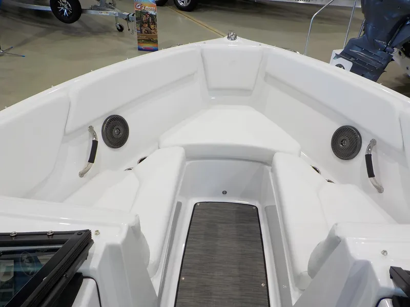 Slide: The Image of 2024 Four Winns H1 OB boat interior, featuring white seating and built-in speakers. - 36