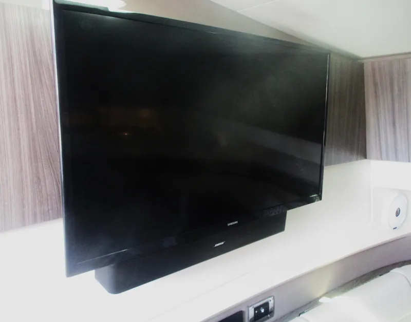 Slide: The Image of Flat-screen TV in the cabin of a 2021 Sea Ray 400 SLX Outboard boat. - 29
