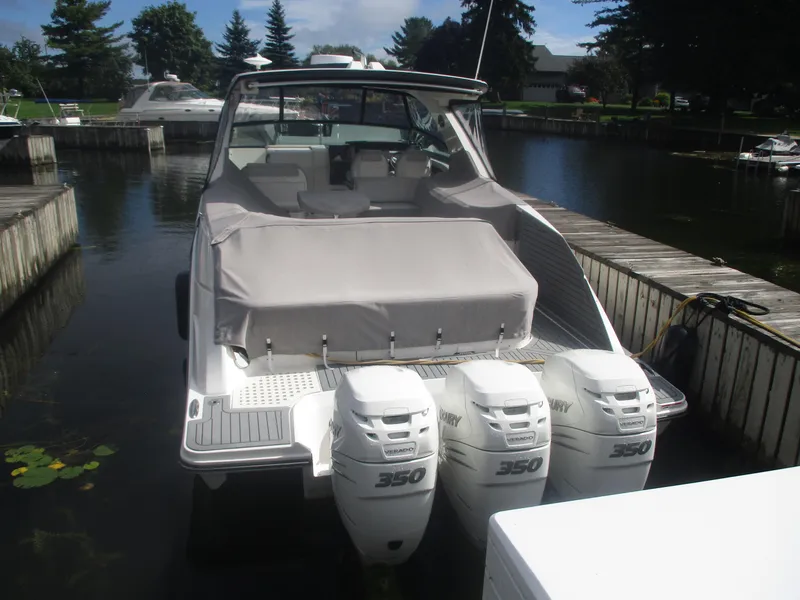 Slide: The Image of 2021 Sea Ray 400 SLX Outboard boat docked, featuring triple 350 horsepower engines. - 3