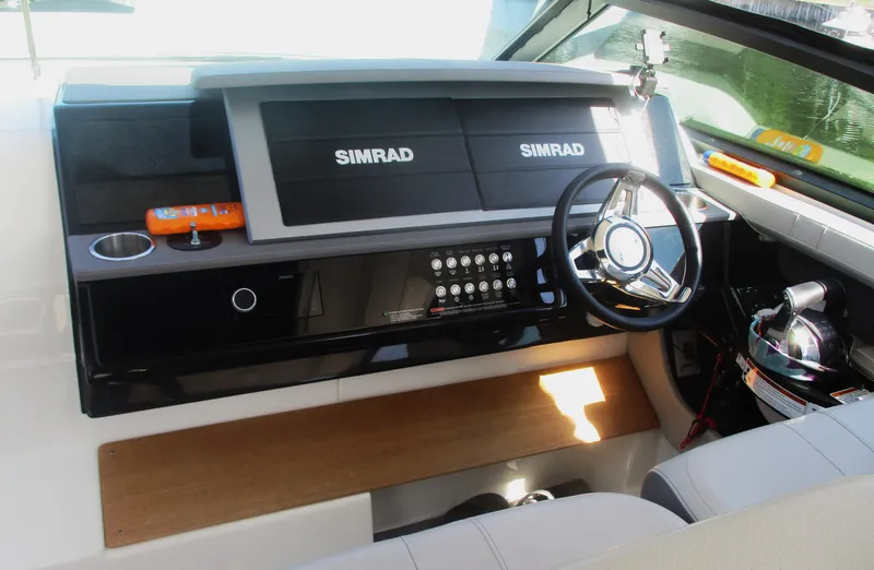 Slide: The Image of 2021 Sea Ray 400 SLX Outboard helm with Simrad displays and modern controls. - 34
