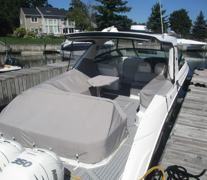 Slide: The Image of 2021 Sea Ray 400 SLX Outboard docked, covered seating area, luxury boat. - 35