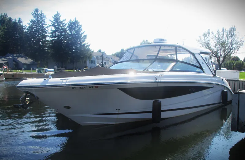 Slide: The Image of 2021 Sea Ray 400 SLX Outboard boat docked on a calm lake. - 43