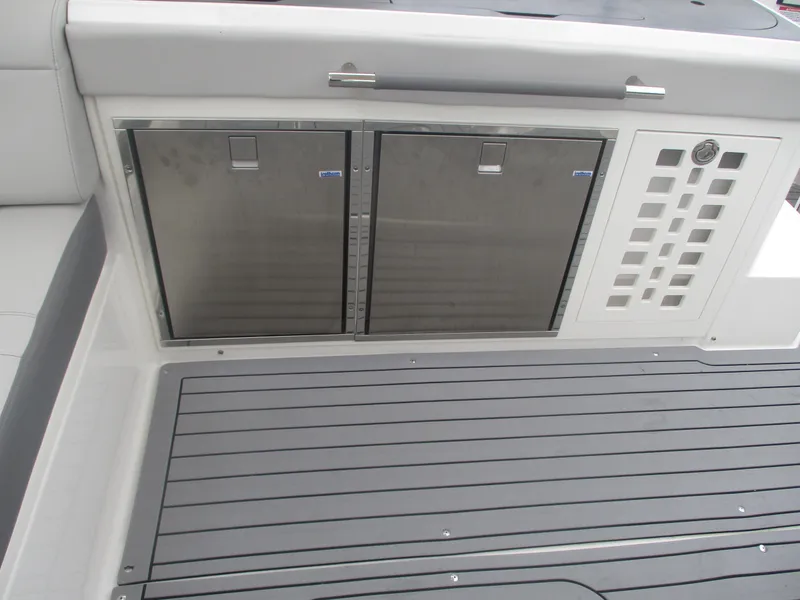 Slide: The Image of 2021 Sea Ray 400 SLX Outboard deck with stainless steel storage compartments. - 9
