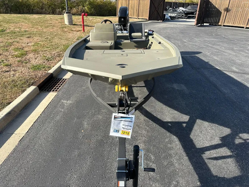 Slide: The Image of 2024 Tracker Grizzly 1754 SC fishing boat on trailer in outdoor setting. - 2
