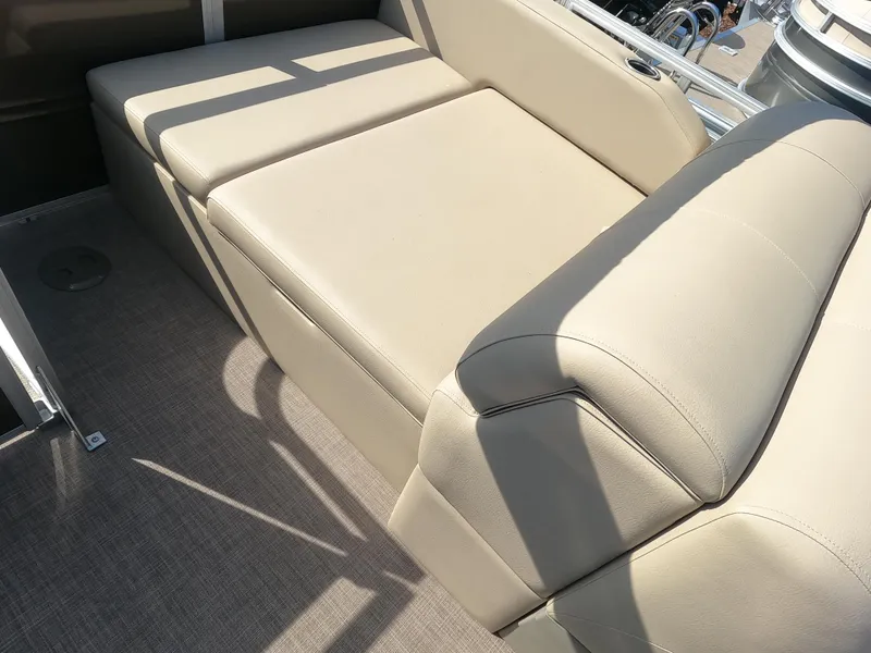 Slide: The Image of Sun Tracker Sportfish 24 XP3 2024 boat interior with beige cushioned seating. - 14
