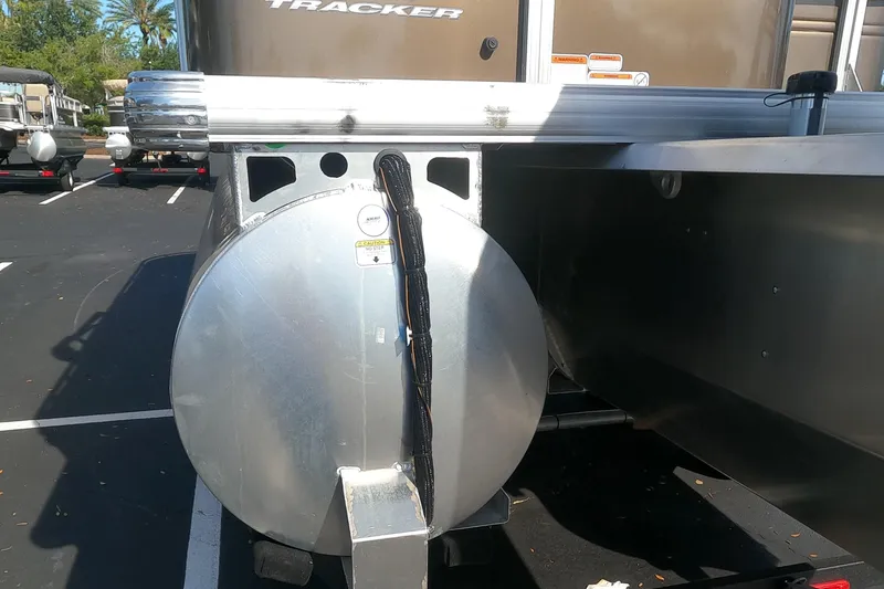 Slide: The Image of 2024 Sun Tracker Sportfish 24 XP3 pontoon boat rear view in parking lot. - 19