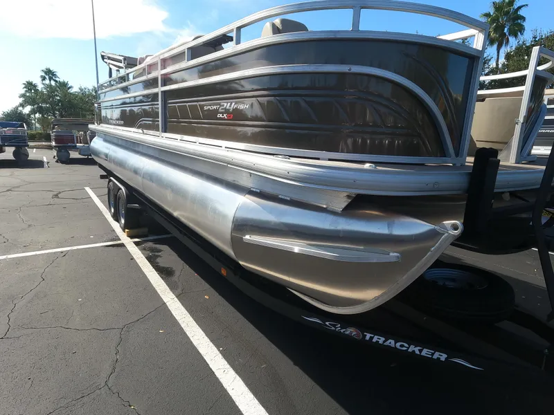 Slide: The Image of 2024 Sun Tracker Sportfish 24 XP3 pontoon boat in a parking lot. - 8