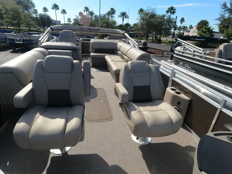 Slide: The Image of 2024 Sun Tracker Sportfish 24 XP3 pontoon boat interior with plush seating. - 9