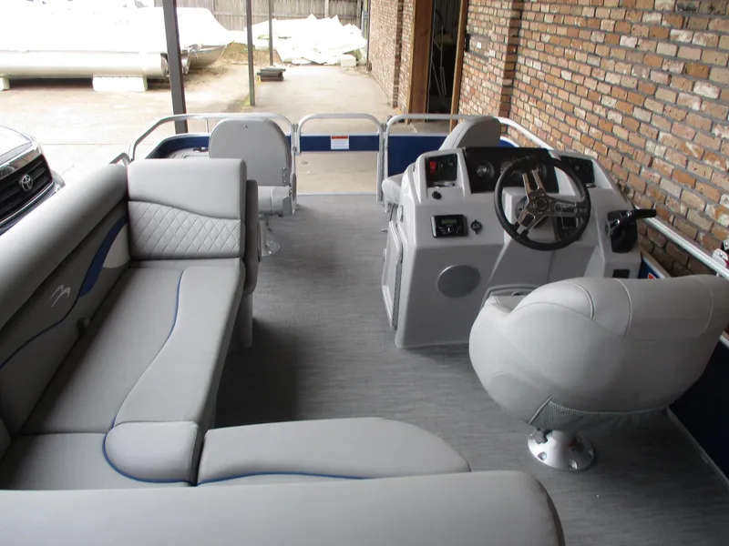 Slide: The Image of 2024 Bennington 18 SF pontoon boat interior with plush seating and modern helm. - 2