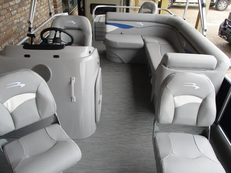 Slide: The Image of 2024 Bennington 18 SF pontoon boat interior with gray seating and steering console. - 5
