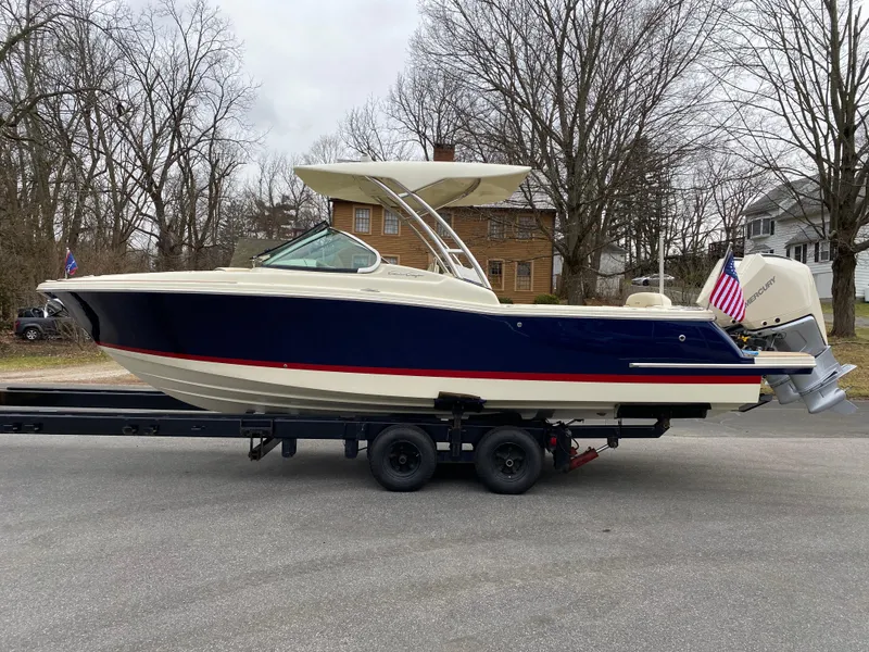 The Image of 2024 Chris-Craft Calypso 28 boat on trailer, side view, outdoors. - 0