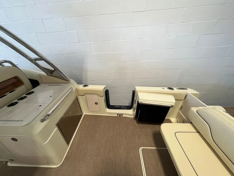 Slide: The Image of 2026 Chris-Craft Calypso 28 boat interior with seating and windshield in a showroom. - 22