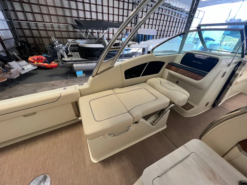 Slide: The Image of 2026 Chris-Craft Calypso 28 boat anchor compartment with wooden deck accents. - 25