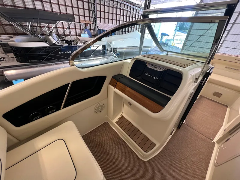 Slide: The Image of 2026 Chris-Craft Calypso 28 boat nameplate with reflective surface. - 29