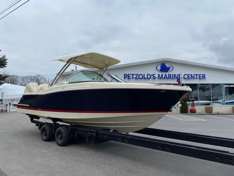 Slide: The Image of 2026 Chris-Craft Calypso 28 interior with beige seating and wooden table. - 5